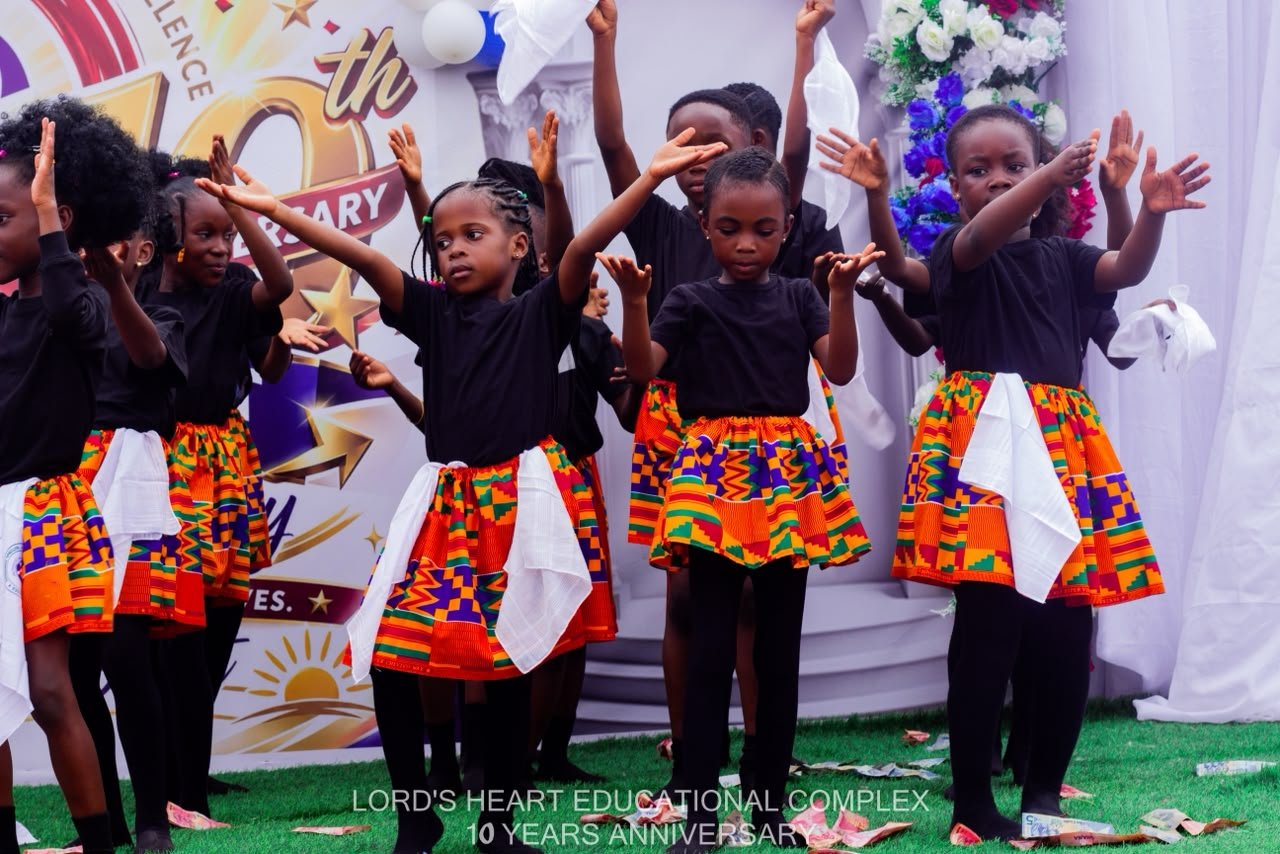 Pupils performing in colourful patterned skirts
