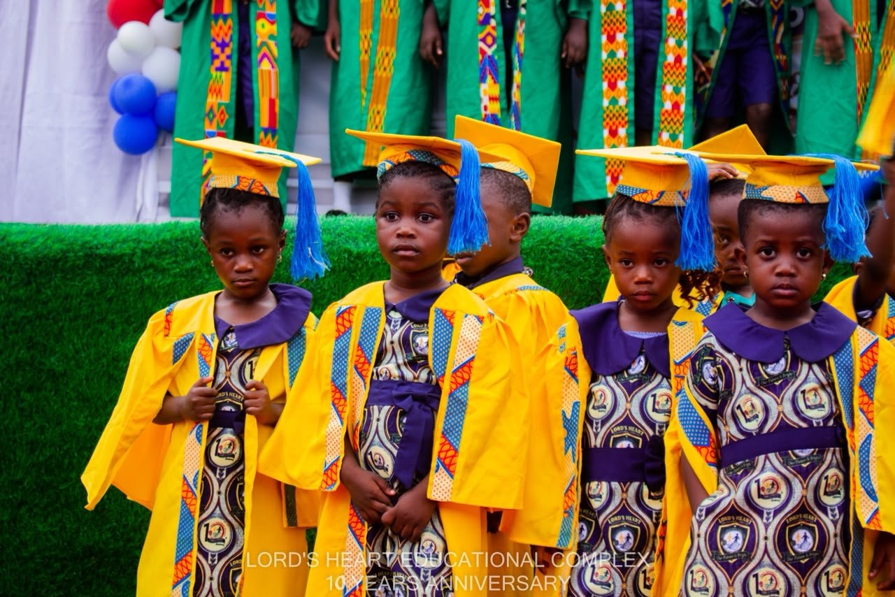 Young Lord’s Heart pupils in yellow graduation gowns